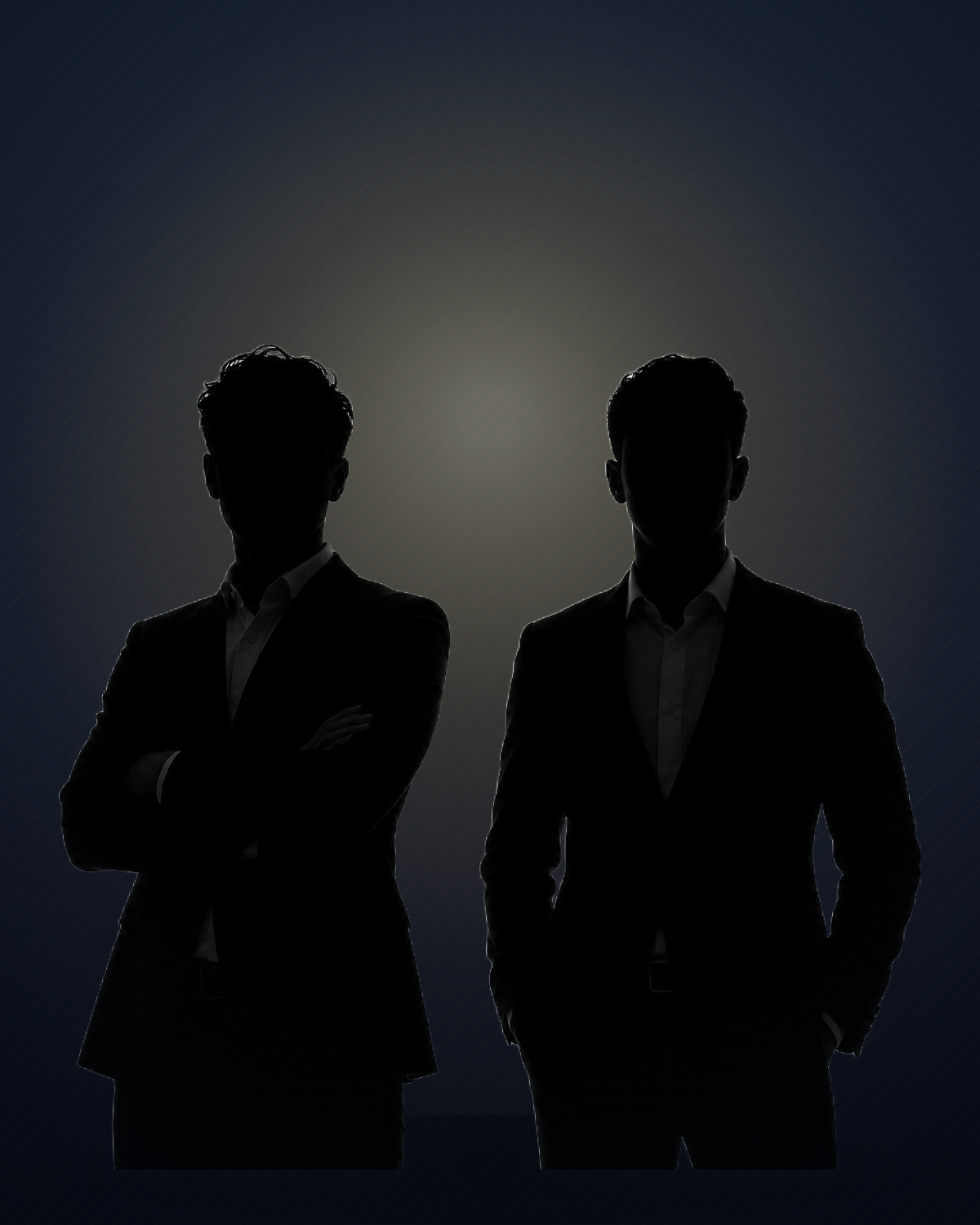 The two founders of Wedsite Studios, in a backlit studio silhouette
